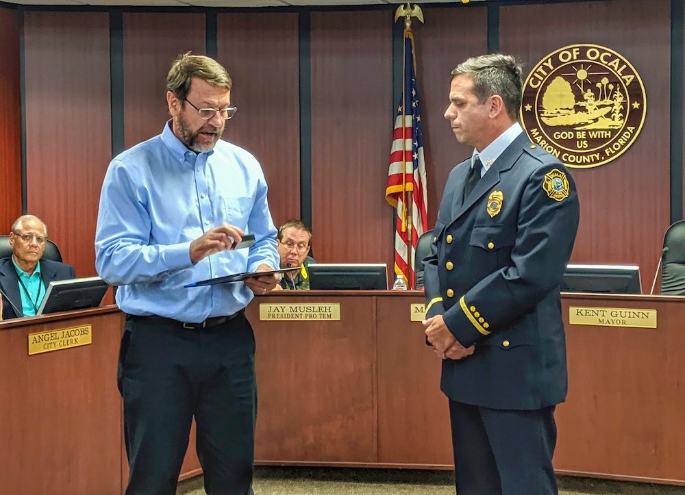 James Williams IV accepts 20-year service award from Ocala City Manager John Zobler