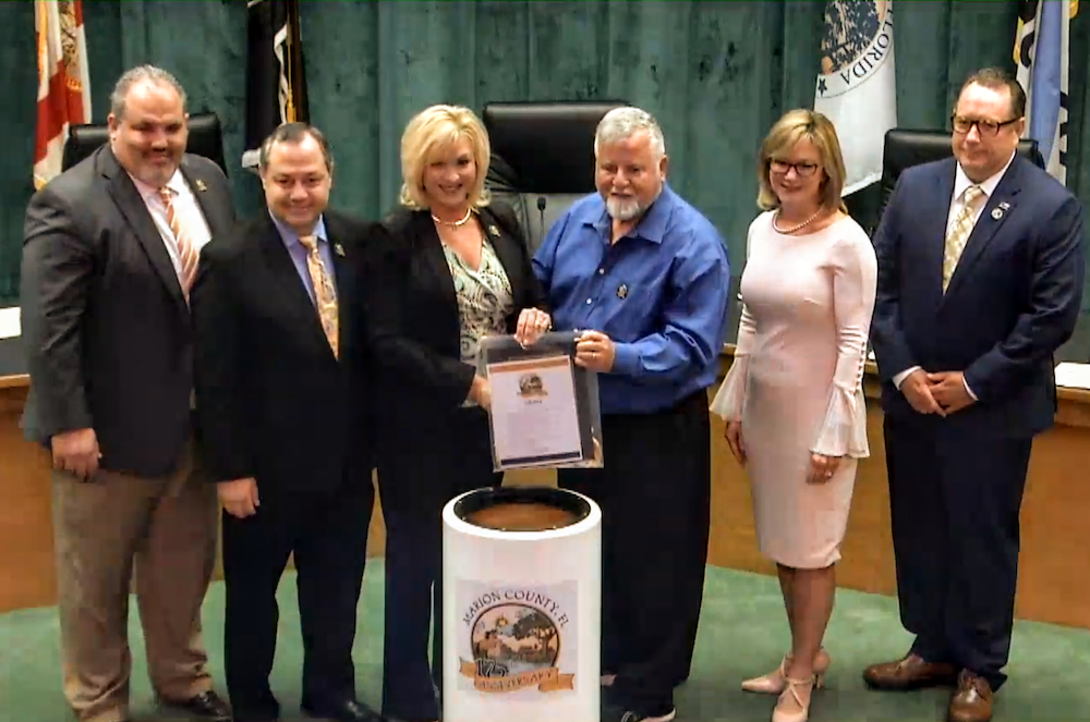 Mayor Dale Burns of Dunnellon presents city items for Marion County time capsule