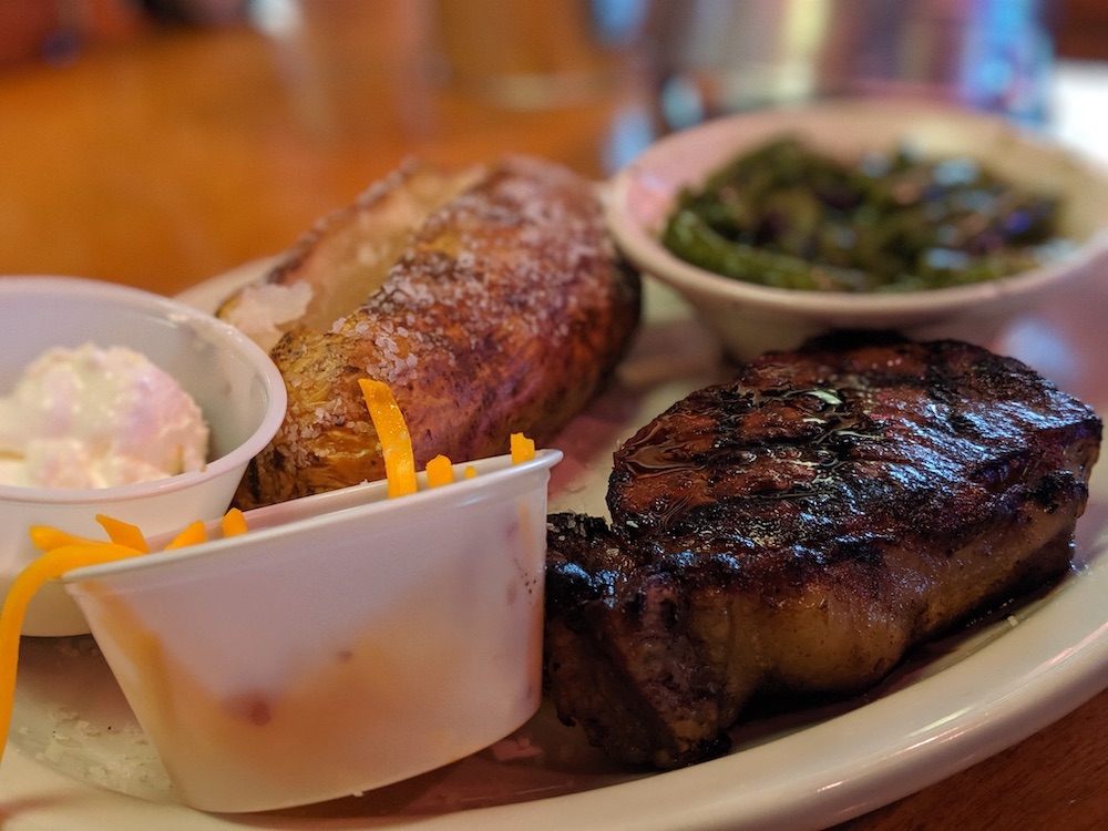 Steak, baked potato, and green beans at Texas Roadhouse in Ocala, Florida