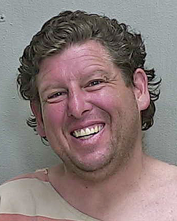 Panhandler infamous for big smile and pink bra back behind bars