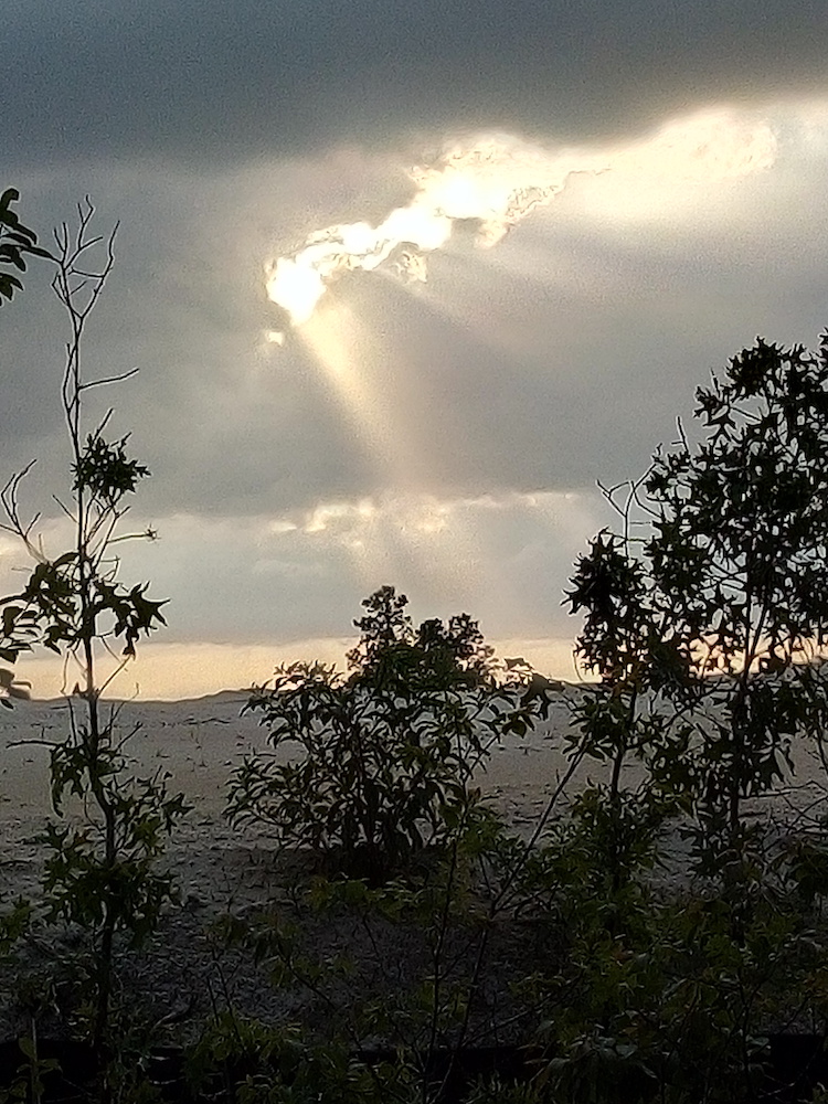 Sun Coming Through Clouds At On Top Of The World