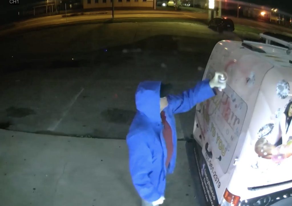 Man spray painting noose KKK on van in Ocala