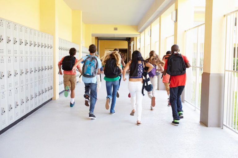Students running down school hallway