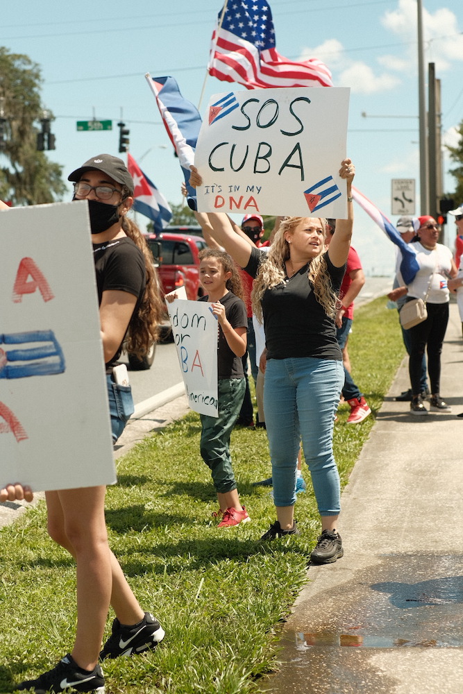 Cuban protester holds "SOS Cuba" sign in Ocala Florida Photo courtesy of Tommy Cuevas