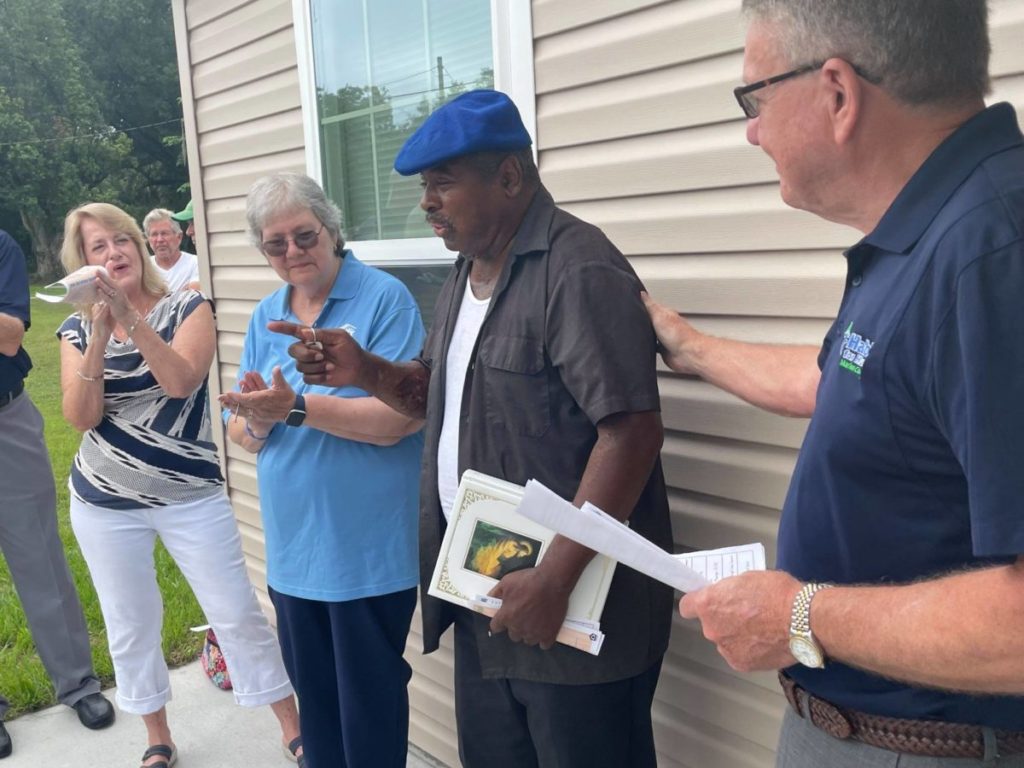 Ed accepts home from Habitat for Humanity of Marion County