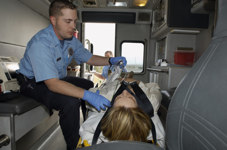 Paramedic EMT in ambulance with victim