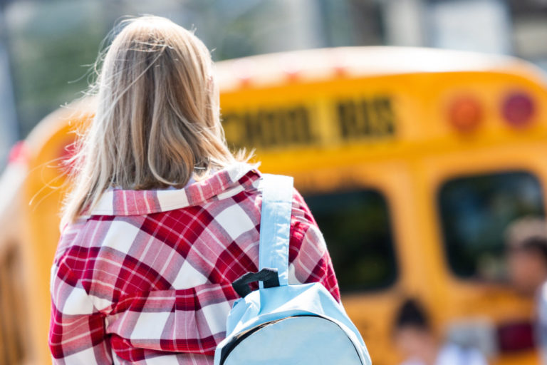 Teenage student walking to bus