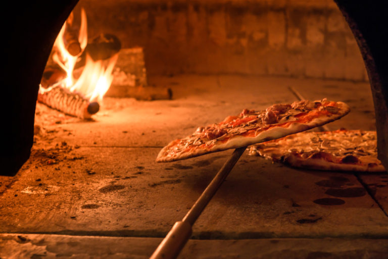 Wood fired oven with pizza