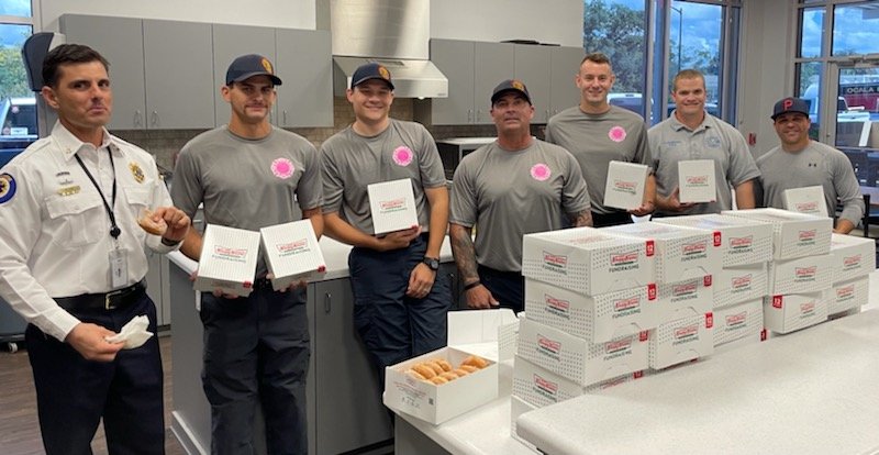 Marion County first responders eating Krispy Kreme donuts