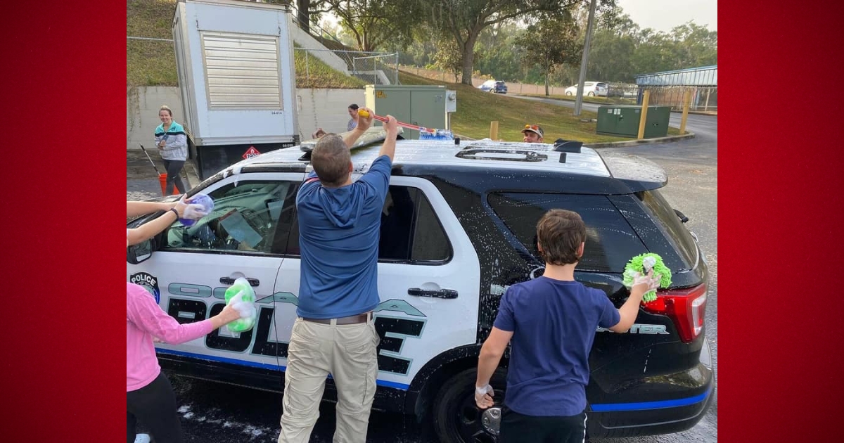 Local middle school students surprise Ocala Police Department with car wash 1