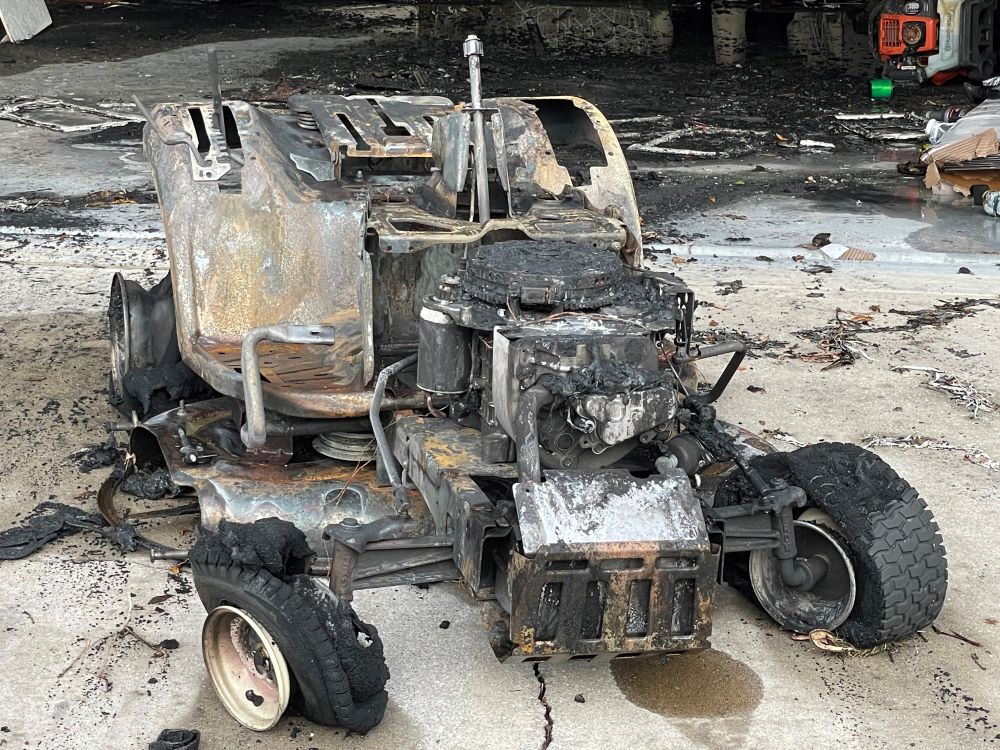 OFR fire inside residential garage August 29 2022 closeup of lawn mower