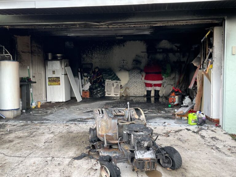OFR fire inside residential garage August 29 2022 photo of lawn mower and garage