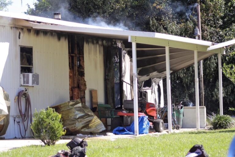 MCFR rescues woman dog from mobile home fire October 2 2022 photo of mobile home with smoke photo from Ocala Fire Rescue