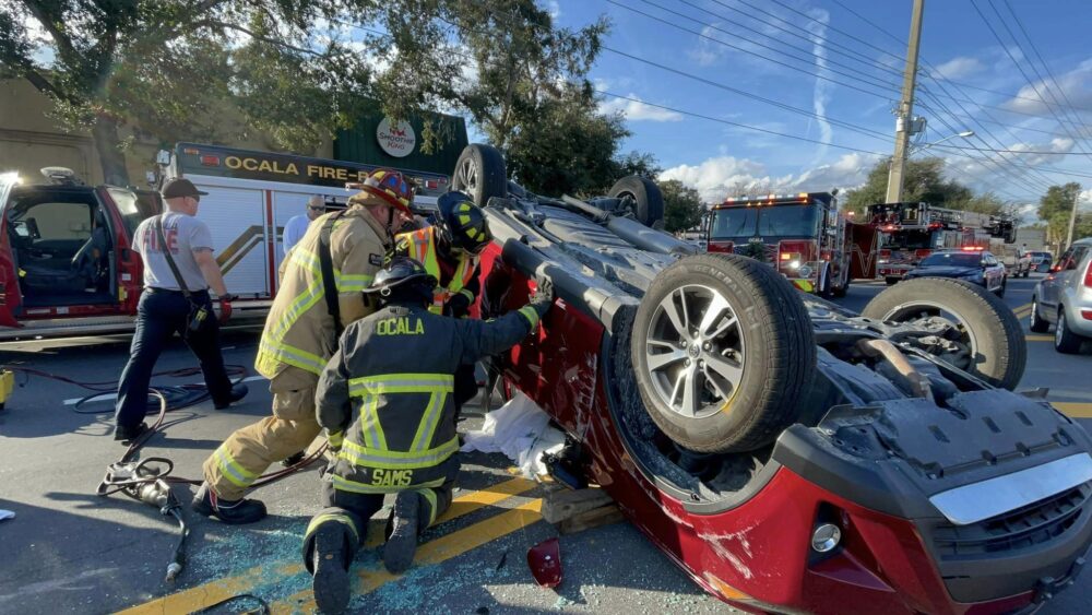 Crash with rollover (December 5, 2022) - Ocala Fire Rescue firefighters stabilizing SUV