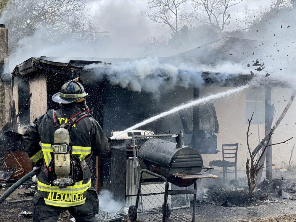 Ocala house fire January 4 2023 firefighter attacking fire with hose Ocala Fire Rescue