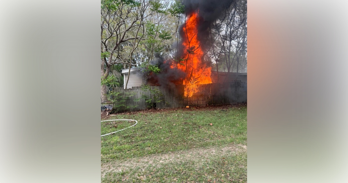 Marion County Fire Rescue combats Citra home fire on March 10, 2023 - flames and heavy smoke rising from home