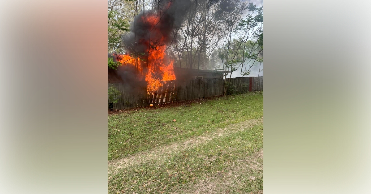Marion County Fire Rescue combats Citra home fire on March 10, 2023 - exterior shot of home with flames and heavy smoke
