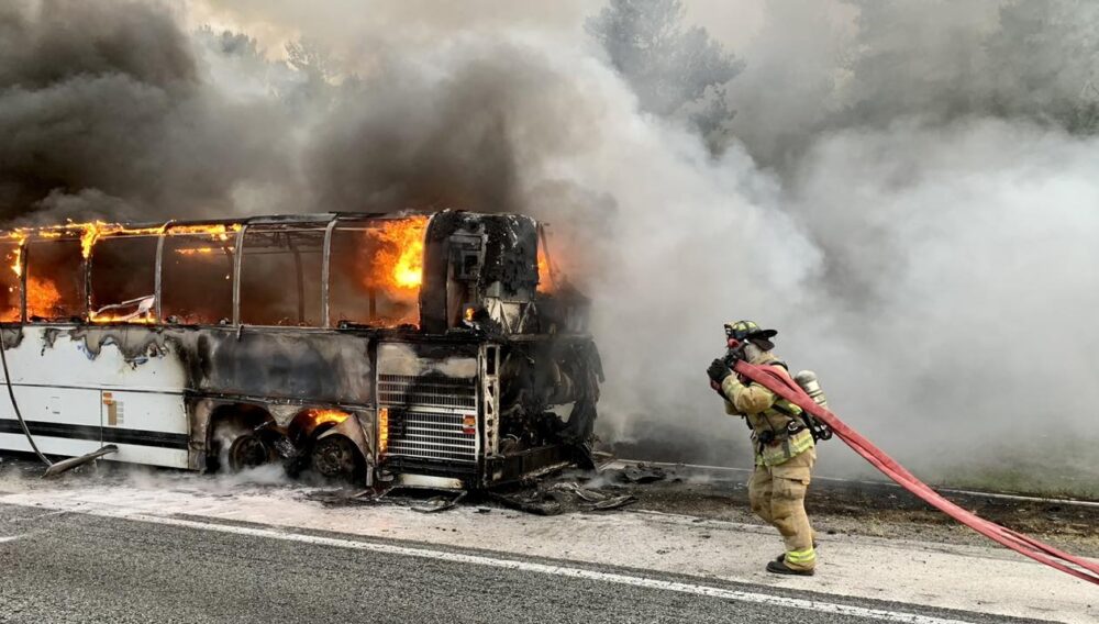 MCFR tour bus fire on Interstate 75 on March 29, 2023 - firefighters extinguishing flames
