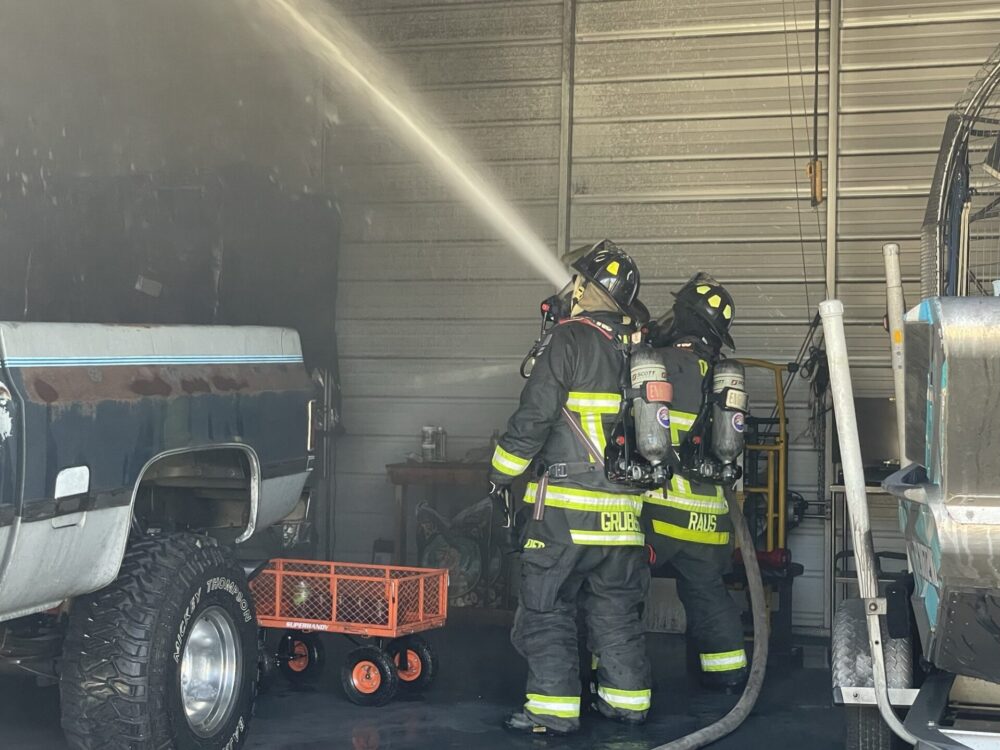 Ocala Fire Rescue garage fire April 4 2023 firefighters inside garage spraying water