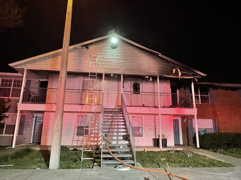 The Morgan apartment fire in Ocala April 1 2023 exterior of building with ladder and hose visible