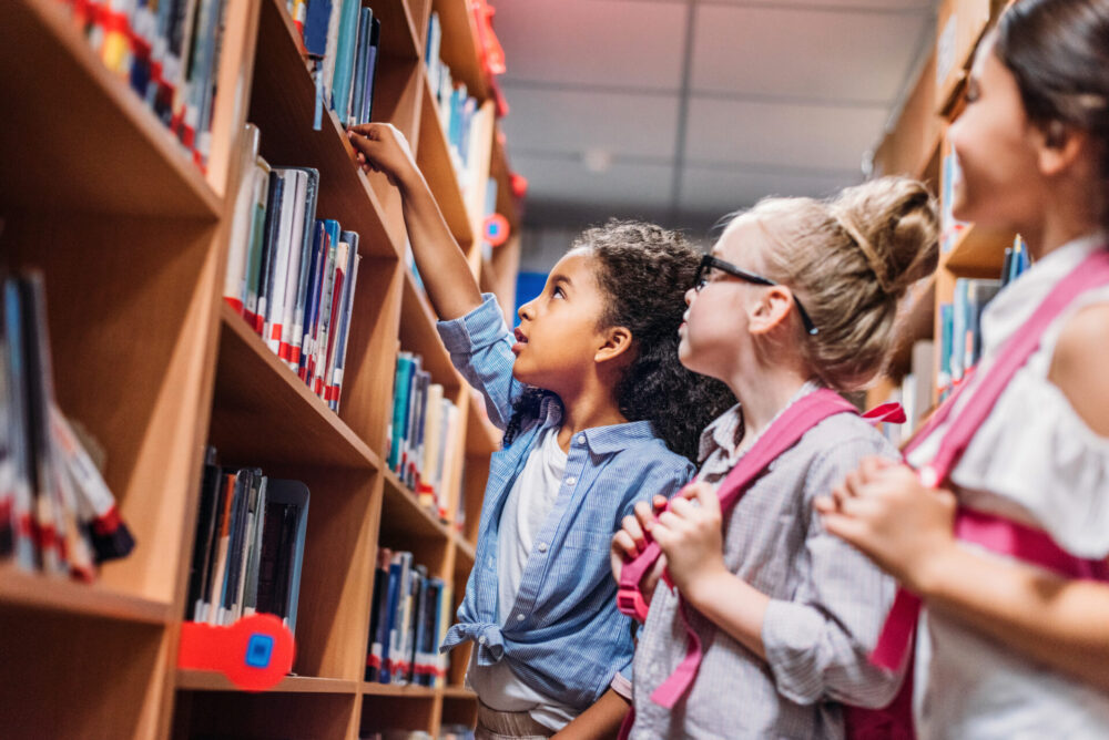 Young girls at school library (stock image)