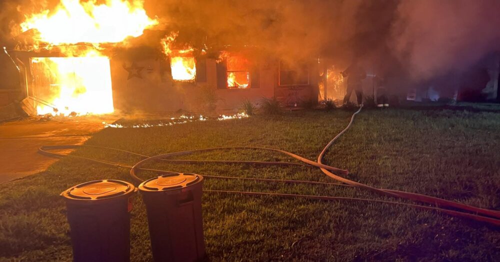 MCFR and OFR respond to Ocala house fire on June 29, 2023 photo of hose lines as firefighter battles flames (MCFR Battalion Chief 3)