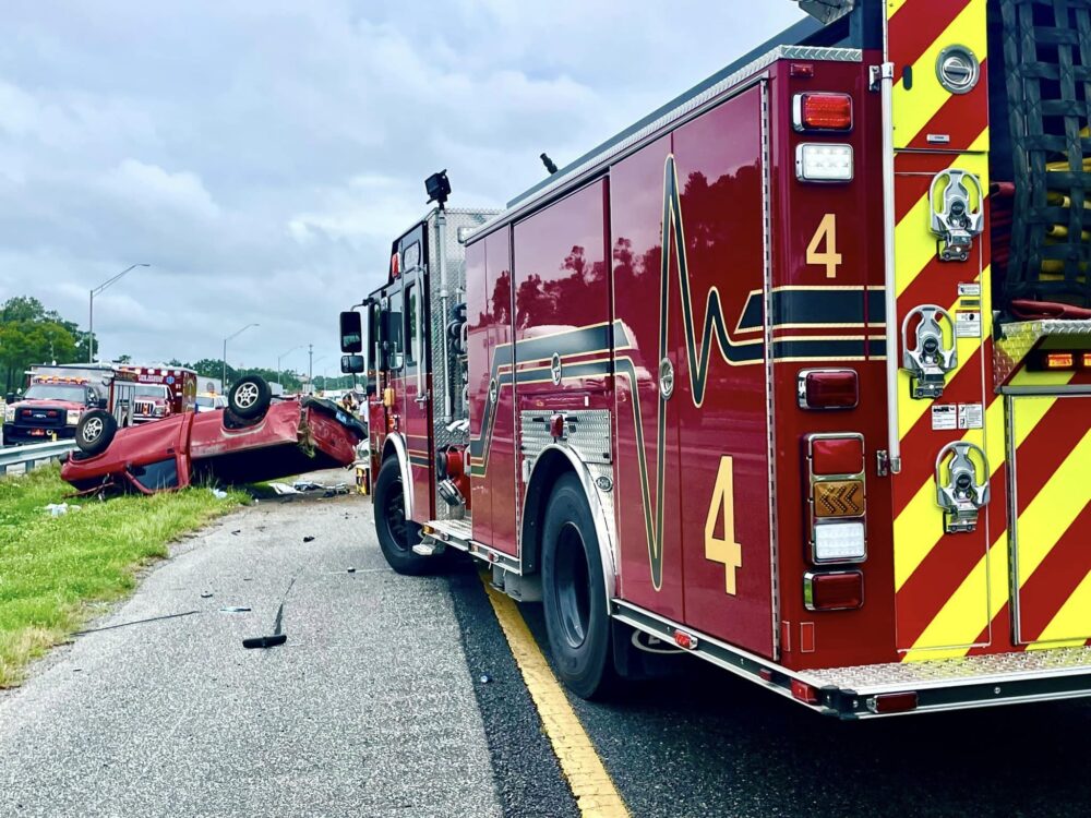 Afternoon crash on I 75 in Marion County on July 11, 2023 red pickup truck on roof with fire truck nearby
