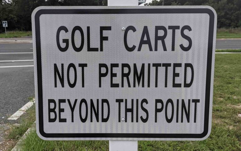 Golf carts not permitted beyond this point sign