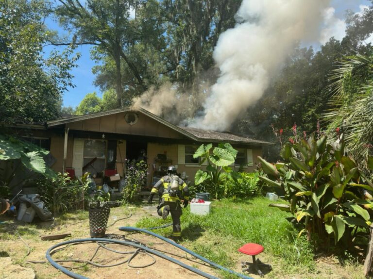 Marion County Fire Rescue and Ocala Fire Rescue respond to Ocala house fire on August 1, 2023 firefighter approaching home (photo MCFR)