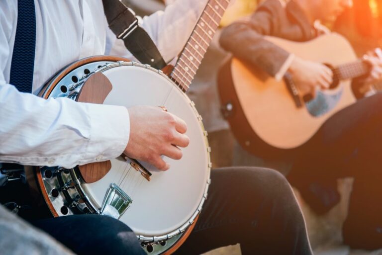 Bluegrass stock image closeup of banjo and guitar players