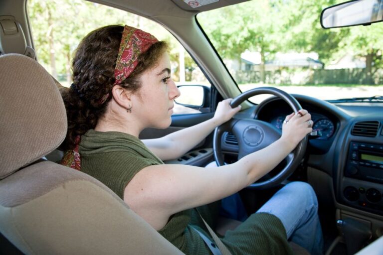 Teen driver looking both ways (stock image)