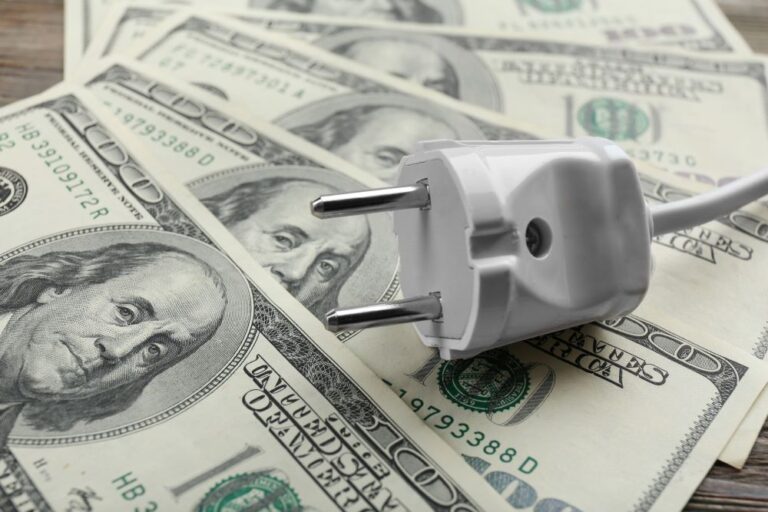 plug on $100 bills (stock image for high electric bills)