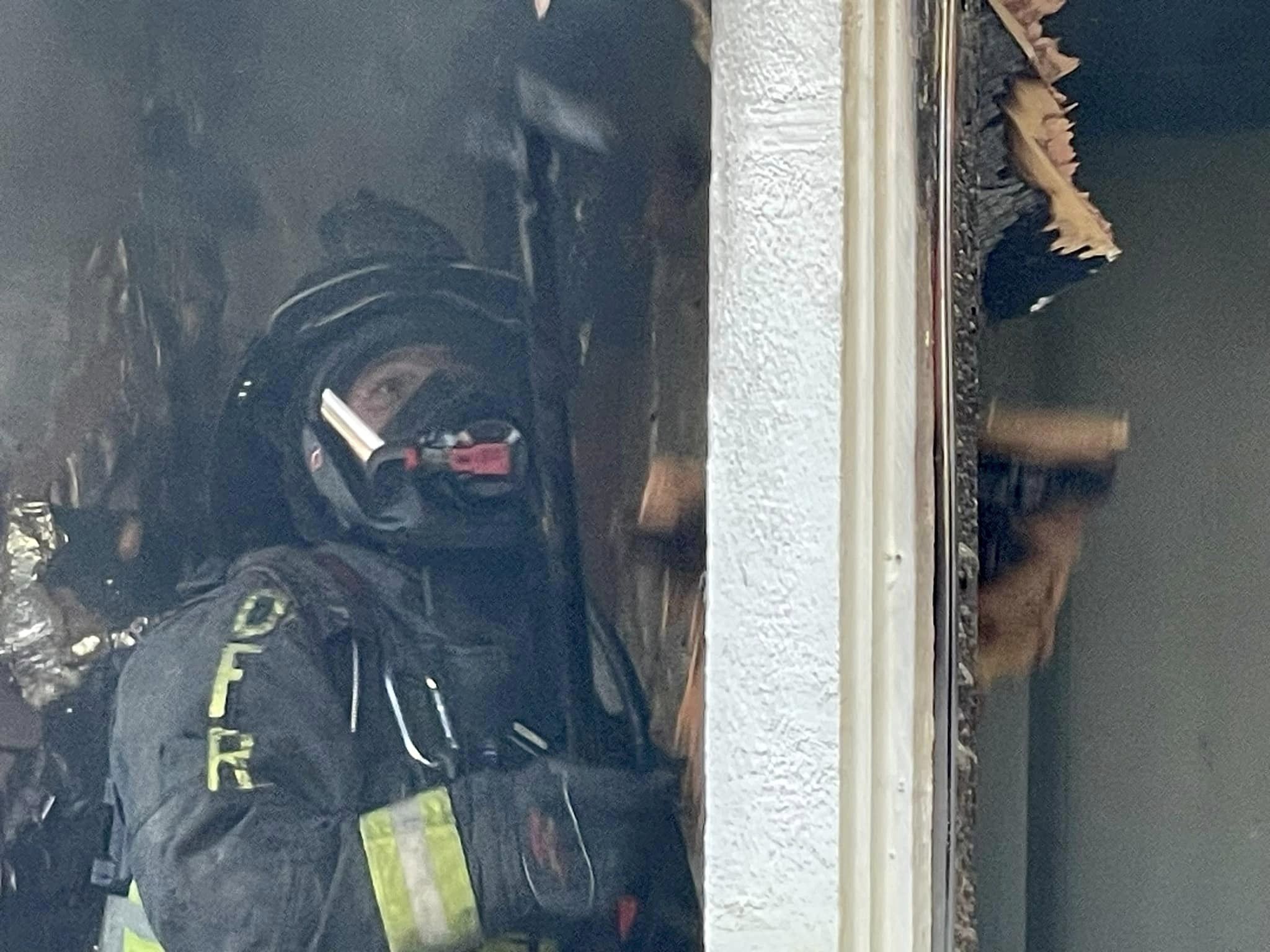 Ocala Fire REscue apartment fire on back porch (December 19, 2023) firefighter battling fire