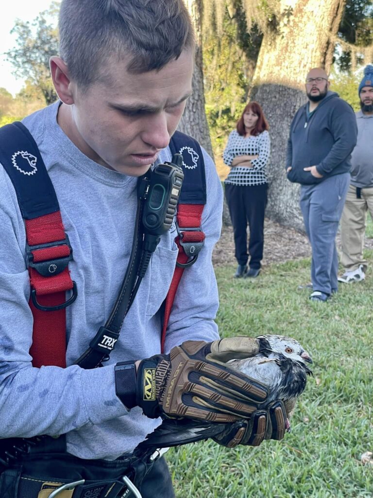 Ocala Fire REscue apartment fire on back porch (December 19, 2023) firefighter rescuing pet bird