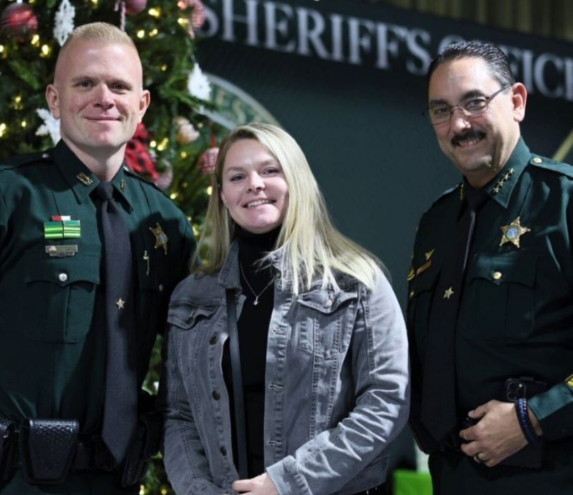MCSO Detective John Lightle with Gabrielle (Selah Freedom) and Sheriff Billy Woods (December 20, 2023 medal of commendation) 2
