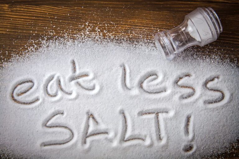 Eat less salt pile of salt and empty shaker (stock image)