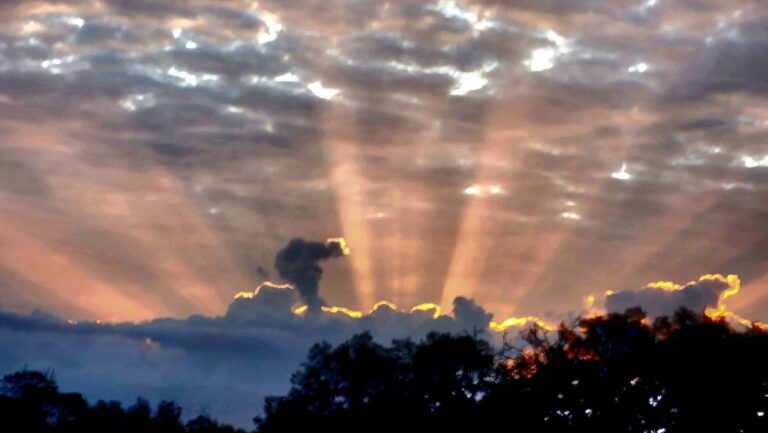 Morning sun rays burst through clouds over Ocala