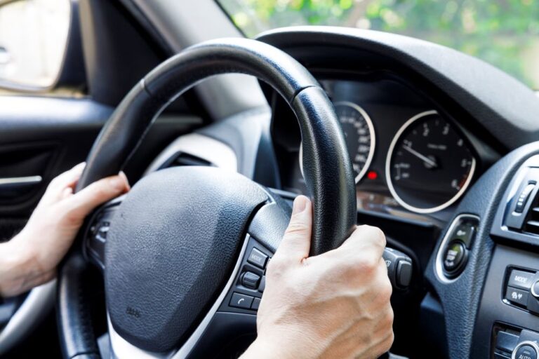 driver's hands on steering wheel