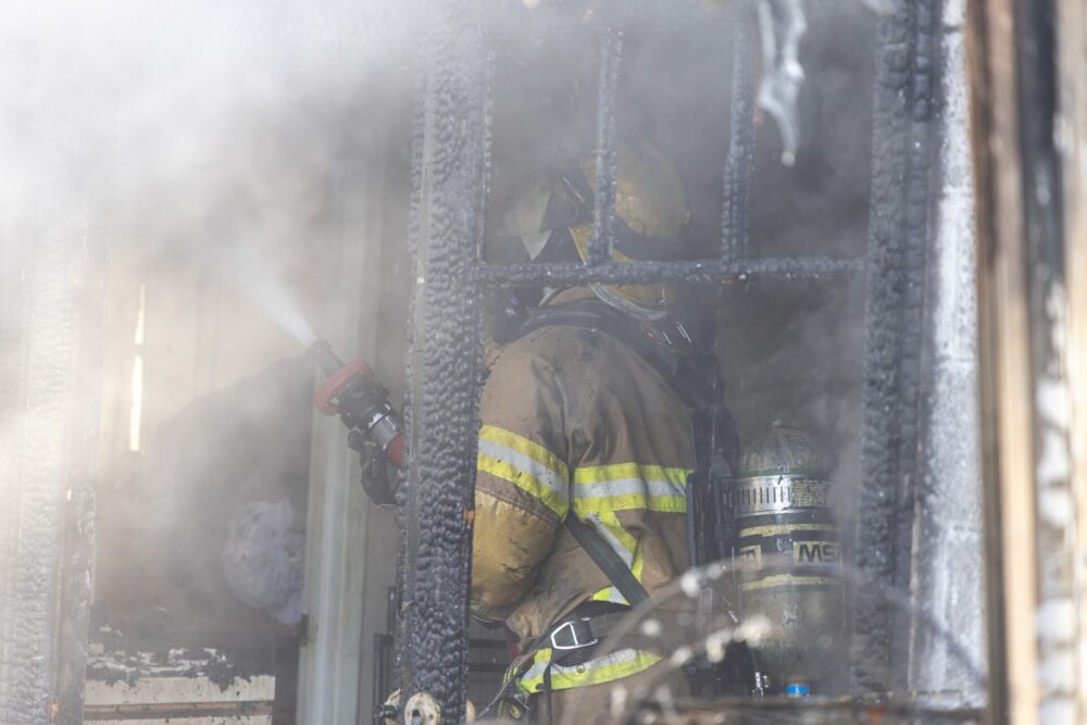 House fire in Belleview on March 12, 2024 closeup of firefighterr battling fire inside home (2) (photo MCFR)