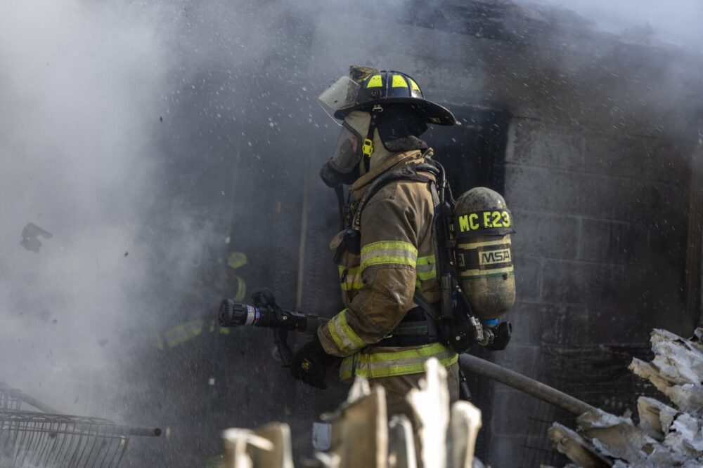 House fire in Belleview on March 12, 2024 closeup of firefighterr battling fire (photo MCFR)