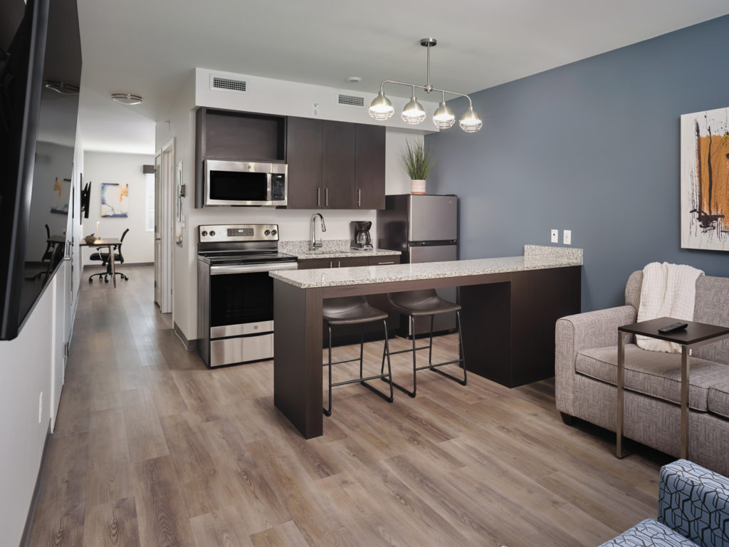 Living room and kitchen in one of the suites at stayAPT Suites in Ocala (Photo stayAPT Suites)
