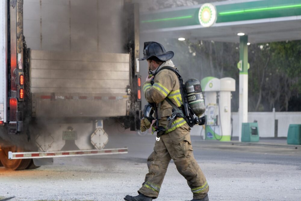 MCFR tractor trailer fire at BP gas station in Ocala on 3 20 24 firefighter at rear of vehicle (photo by MCFR)