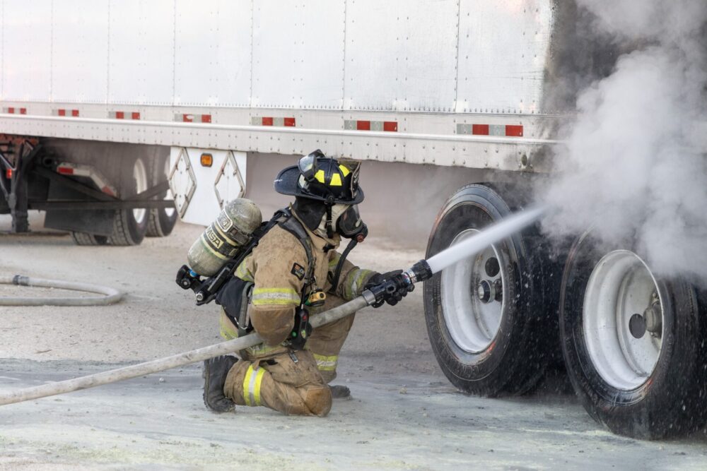 MCFR tractor trailer fire at BP gas station in Ocala on 3 20 24 firefighter blasting vehicle with water (photo by MCFR)