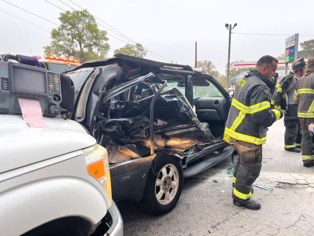 Two vehicle crash in northeast Ocala on March 5, 2024, sends three to hospital firefighters standing near SUV (2) (photo by MCFR)
