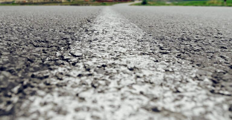 White line on gravel and asphalt roadway