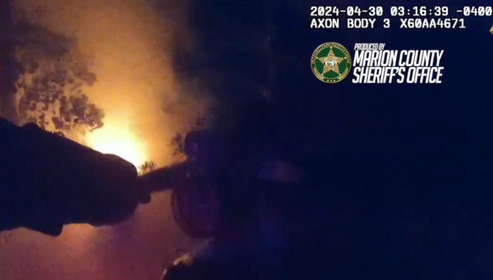 An MCSO deputy using a fire extinguisher to combat one of the fires in the Silver Springs Preservation Area.
