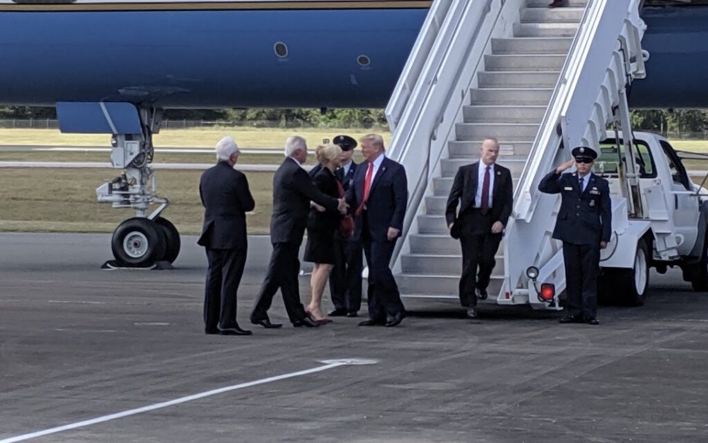 Marion County Commissioner Michelle Stone and former Mayor of Ocala Kent Guinn greet Donald Trump at the Ocala International Airport on October 3, 2019. (Staff photo)