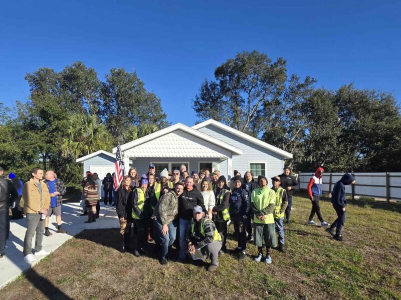 Jessica Rehak center and others in front of her new home from Habitat for Humanity of Marion County