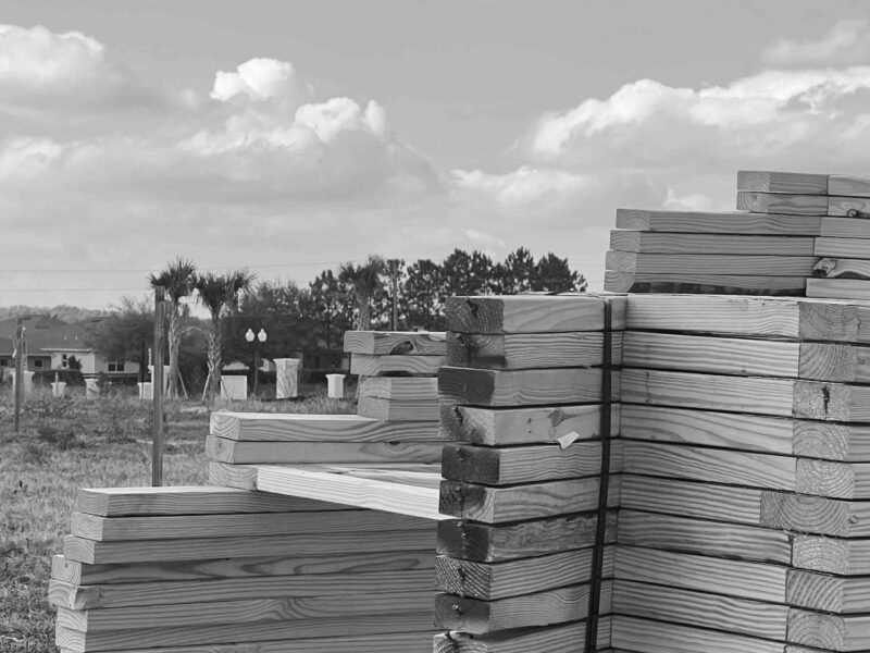 2x4 wood in stacks next to job site in Ocala