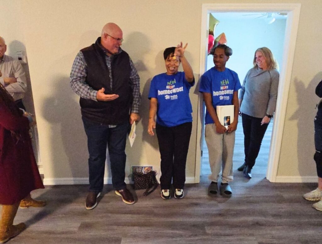 Brittani Davis holding up the keys to her new home